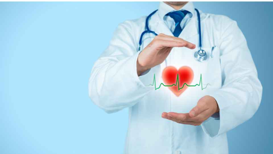 person in white lab coat and stethoscope holding a hologram of a heart