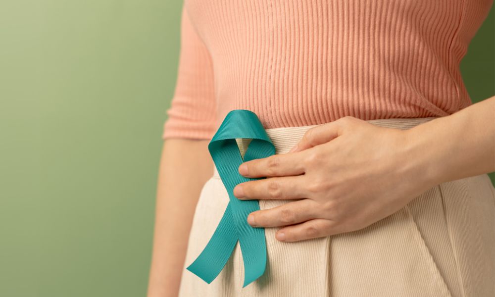 woman holding teal banner to tummy