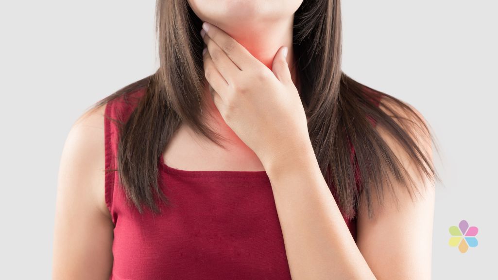 Woman holds her thoat with one hand.