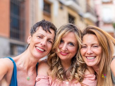 3 smiling women wearing lipstick