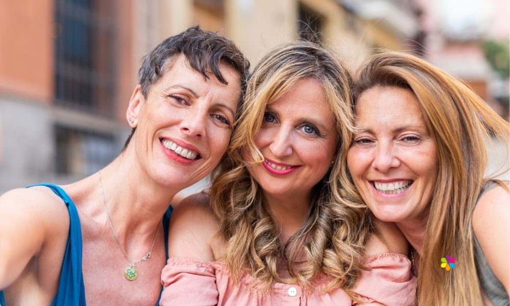 three smiling women wearing lipstick