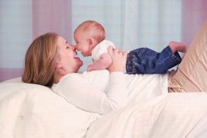 mother and baby laugh nose to nose